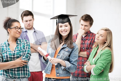 Image of girl in graduation cap with certificate