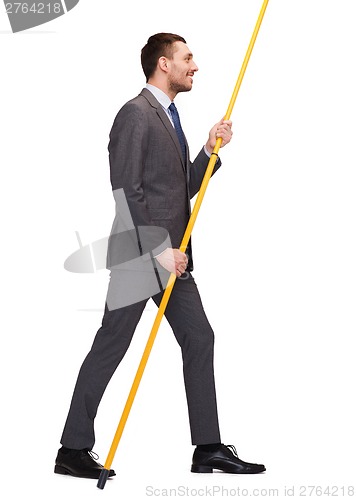 Image of smiling man holding flagpole with imaginary flag