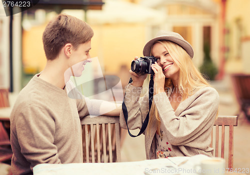 Image of couple taking photo picture in cafe