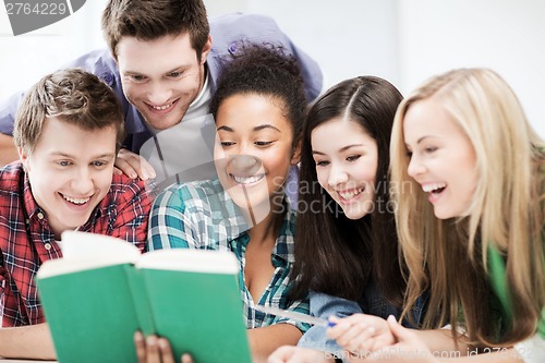 Image of students reading book at school