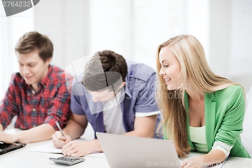 Image of students writing test or exam in lecture at school