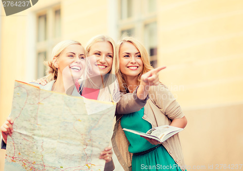 Image of beautiful women with tourist map in the city