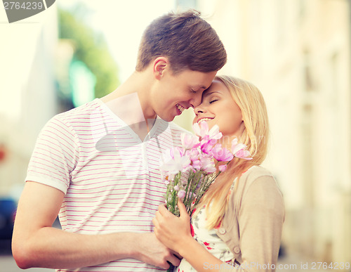 Image of couple with flowers in the city