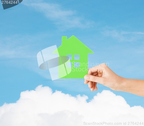 Image of hand holding green paper house