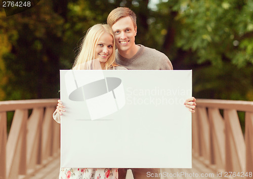 Image of couple on the bridge with blank white board