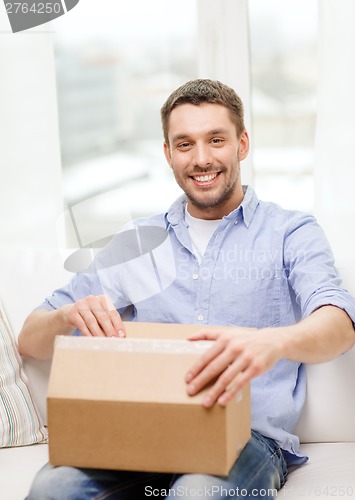 Image of man with cardboard boxes at home