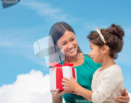 Image of happy mother and child girl with gift box