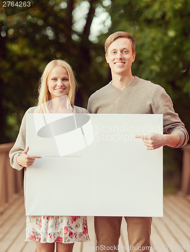 Image of couple on the bridge with blank white board