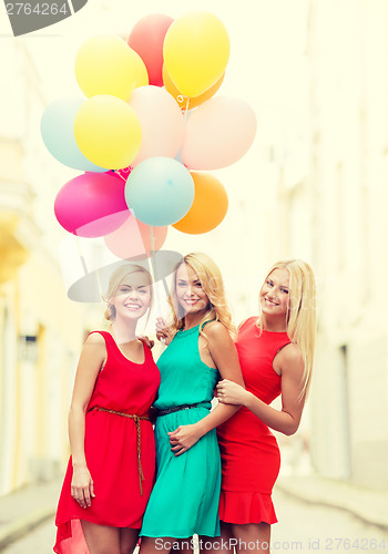 Image of beautiful girls with colorful balloons in the city