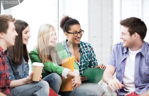 Image of students communicating and laughing at school