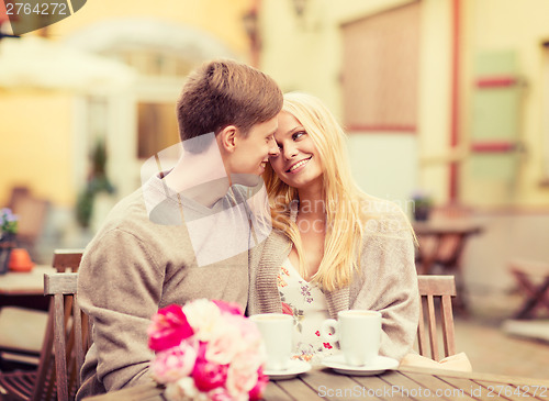 Image of romantic happy couple kissing in the cafe