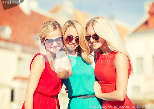 Image of beautiful girls taking picture in the city