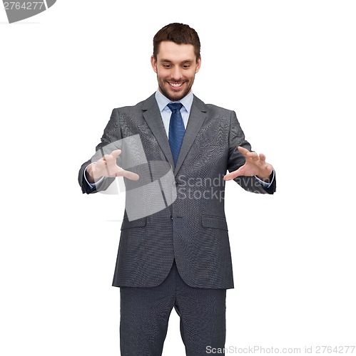 Image of businessman working with imaginary virtual screen