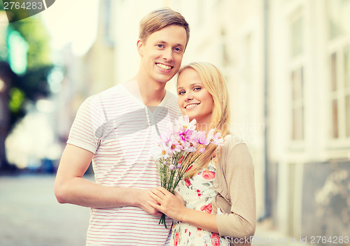Image of couple with flowers in the city