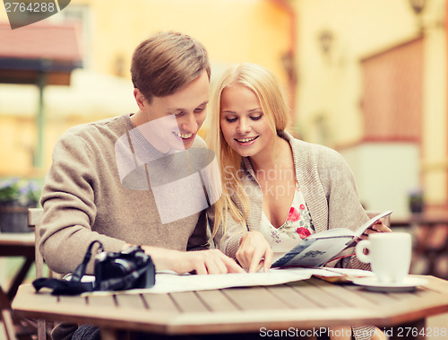 Image of couple with map, camera and travellers guide