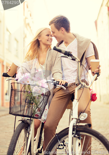 Image of couple with bicycles in the city