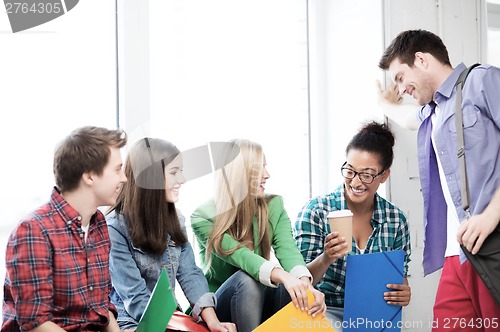 Image of students communicating and laughing at school