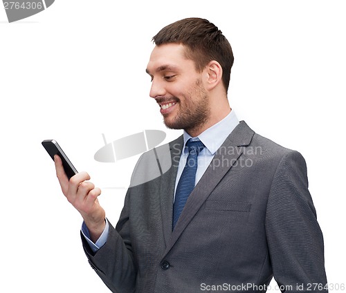 Image of young smiling businessman with smartphone