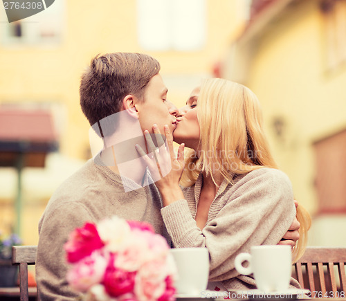 Image of romantic happy couple kissing in the cafe
