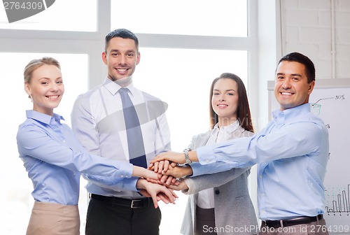 Image of business team celebrating victory in office