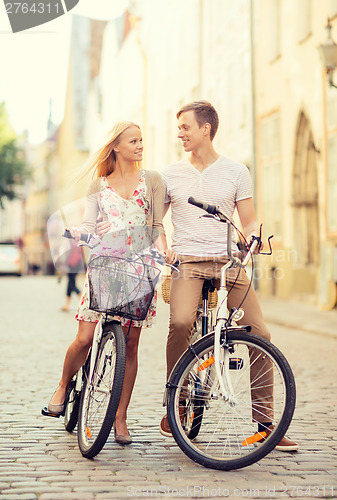 Image of couple with bicycles in the city