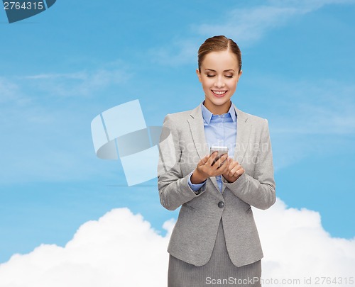 Image of young smiling businesswoman with smartphone