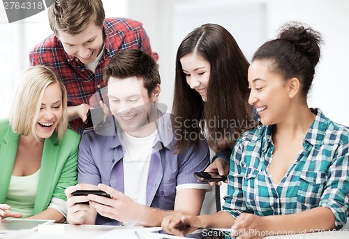 Image of students looking at smartphone at school