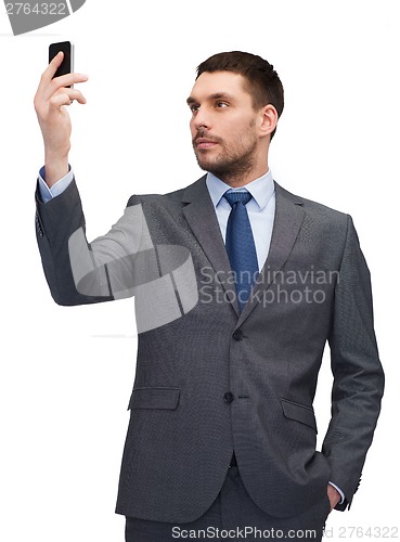 Image of young businessman with smartphone