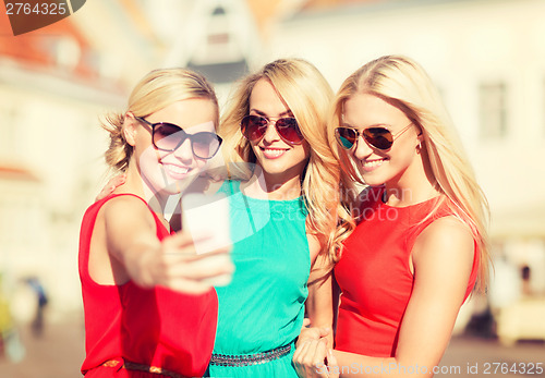 Image of beautiful girls taking picture in the city