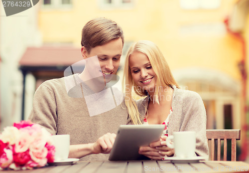 Image of couple with tablet pc in cafe