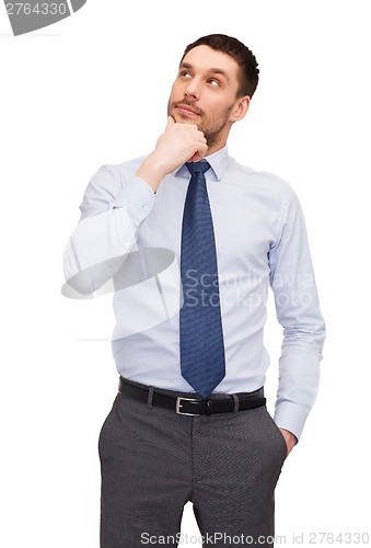 Image of handsome buisnessman looking up