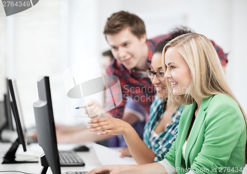 Image of students with computer studying at school