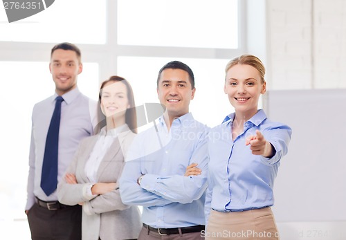 Image of businesswoman in office pointing finger at you