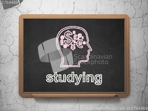 Image of Education concept: Head With Finance Symbol and Studying on chalkboard background