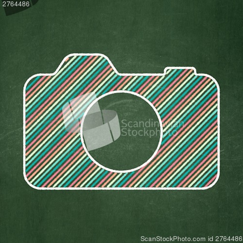 Image of Travel concept: Photo Camera on chalkboard background