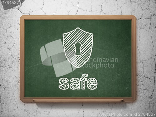 Image of Privacy concept: Shield With Keyhole and Safe on chalkboard background
