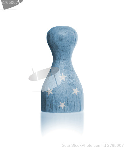 Image of Wooden pawn with a flag painting