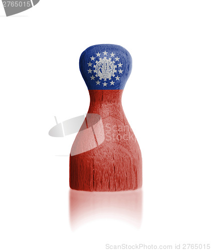 Image of Wooden pawn with a flag painting