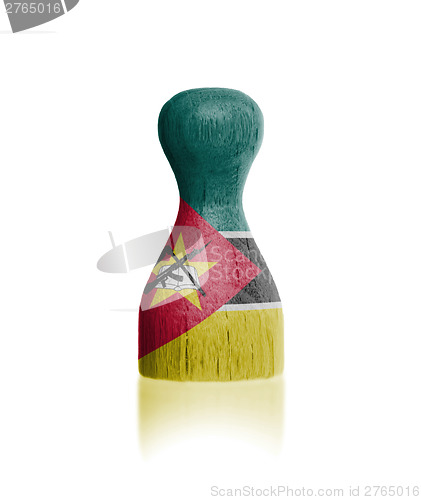 Image of Wooden pawn with a flag painting