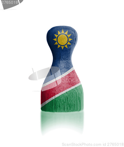 Image of Wooden pawn with a flag painting