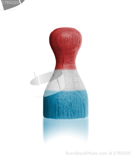 Image of Wooden pawn with a flag painting