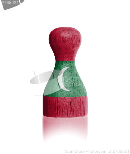 Image of Wooden pawn with a flag painting