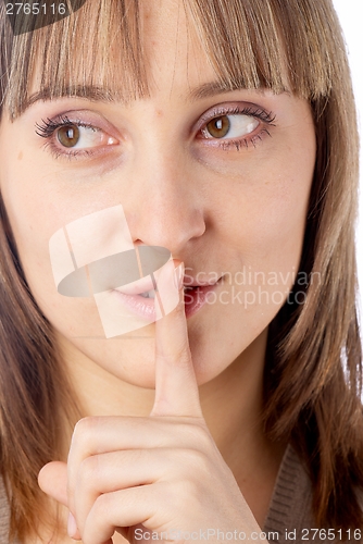 Image of Attractive woman with finger on lips