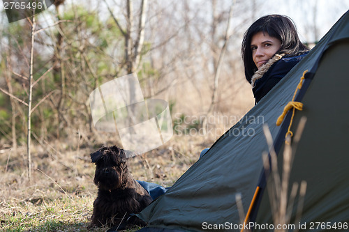 Image of Woman with a dog camping