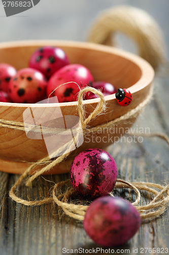 Image of Easter eggs and wooden bowl with ladybug.