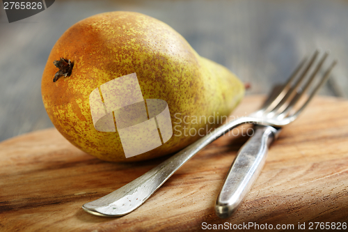 Image of Juicy pear on a cutting board.