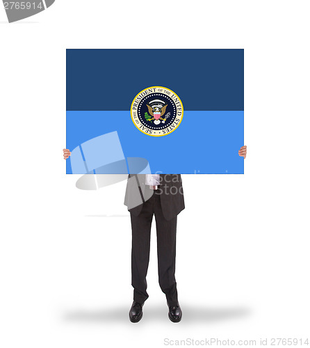 Image of Businessman holding a big card