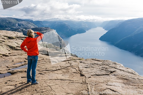 Image of Woman hiker on Pulpit Rock / Preikestolen, Norway