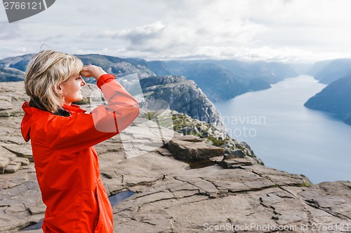 Image of Woman hiker on Pulpit Rock / Preikestolen, Norway