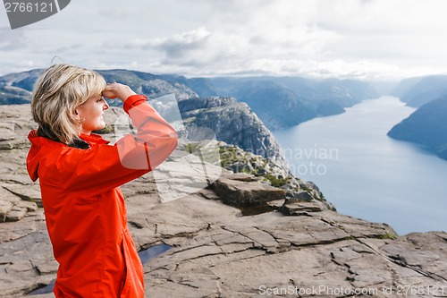 Image of Woman hiker on Pulpit Rock / Preikestolen, Norway
